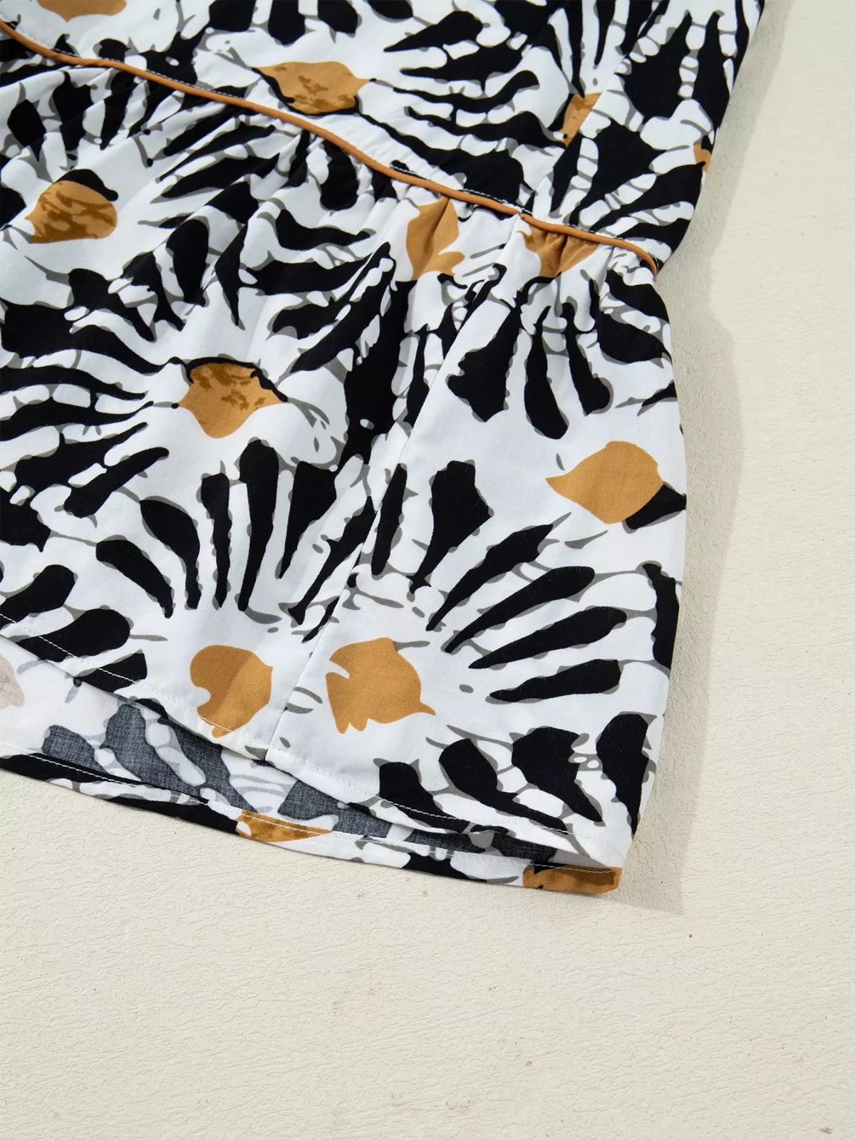 Close-up of a black, white, and tan abstract printed skirt from Shopimist fashion collection