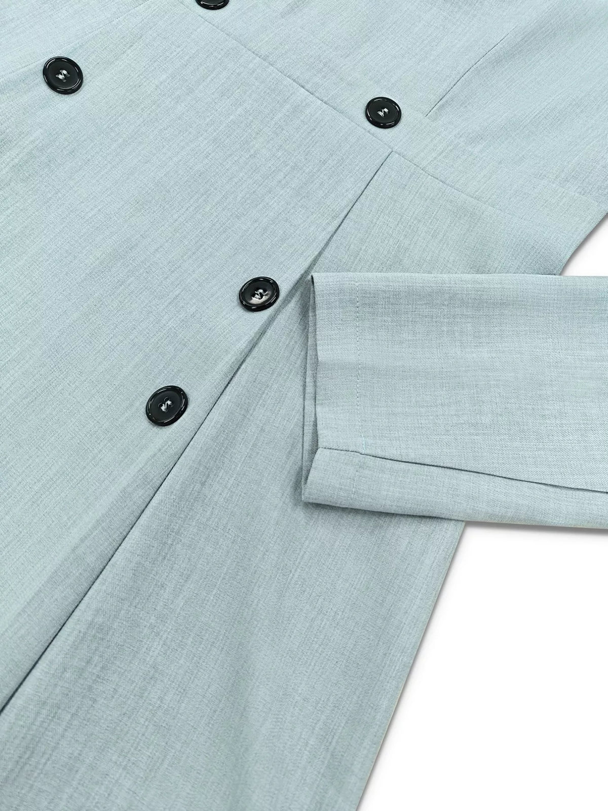 Light blue buttoned shirt with black buttons, close-up on fabric and sleeve from Shopimist fashion.