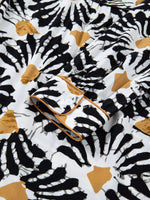 Close-up of a black, white, and mustard abstract print shirt cuff, Shopimist fashion