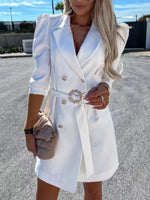 Woman in stylish white belted blazer dress with gold buttons and beige handbag outdoors