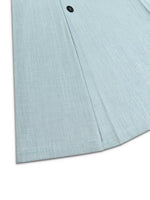 Light blue textured fabric coat hem with black button, stylish apparel from Shopimist