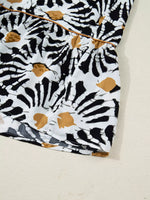 Close-up of a black, white, and tan abstract printed skirt from Shopimist fashion collection