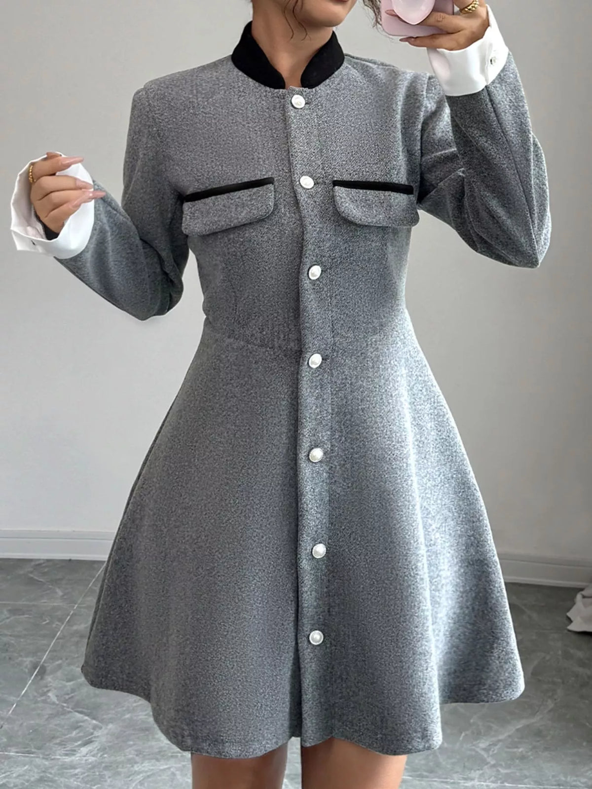 Woman wearing a gray button-up long sleeve dress with front pockets and black collar, Shopimist fashion