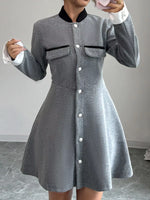 Woman wearing a gray button-up long sleeve dress with front pockets and black collar, Shopimist fashion