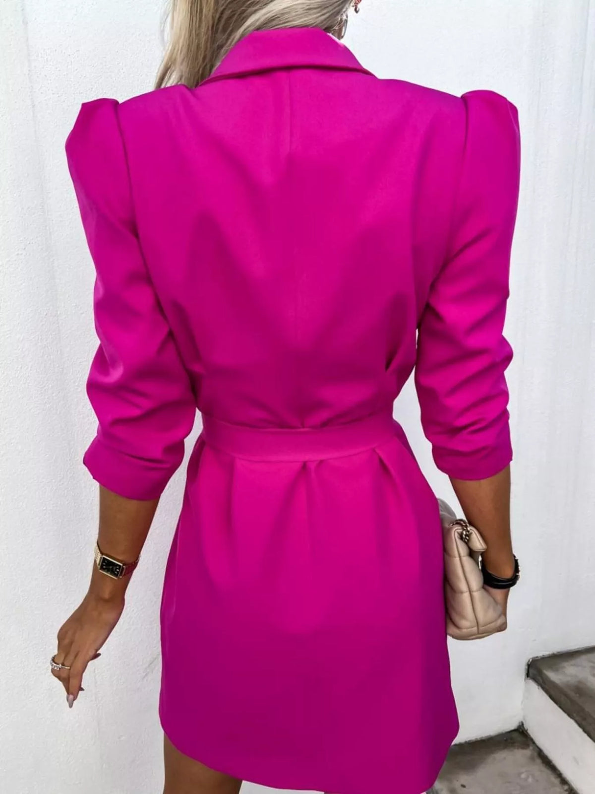 Woman in a bright pink belted blazer dress holding beige purse, trendy fashion from Shopimist