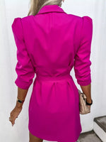 Woman in a bright pink belted blazer dress holding beige purse, trendy fashion from Shopimist