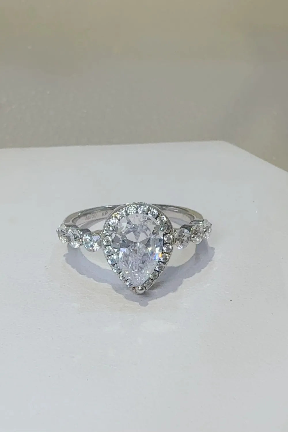 Pear-cut diamond halo ring with side stones on silver band, Shopimist fashion jewelry