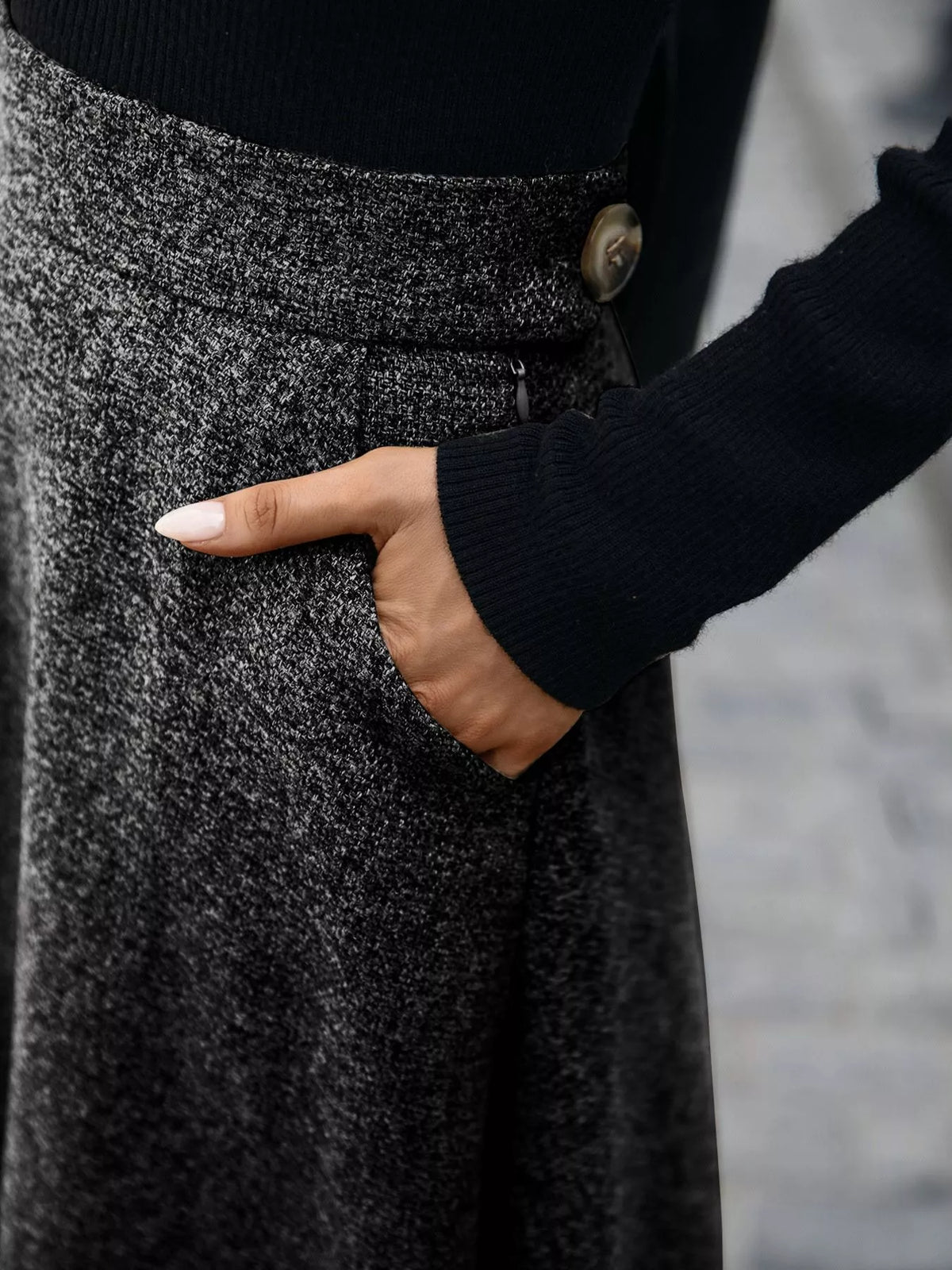 Woman wearing a textured grey skirt with pocket, dressed in black long sleeve top, Shopimist fashion
