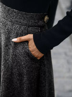 Woman wearing a textured grey skirt with pocket, dressed in black long sleeve top, Shopimist fashion