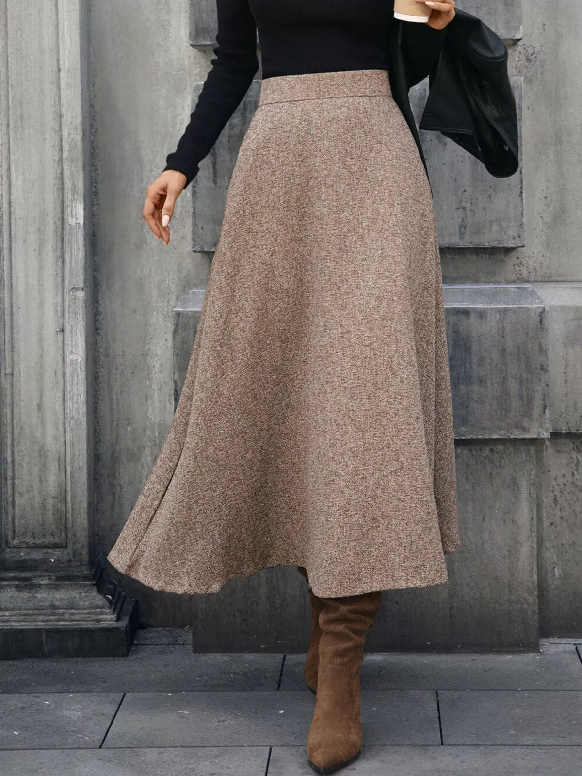 Woman in brown wool midi skirt, black sweater, and suede boots, stylish fall fashion look