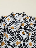 White blouse with black and brown abstract leaf print, v-neck, modern fashion detail