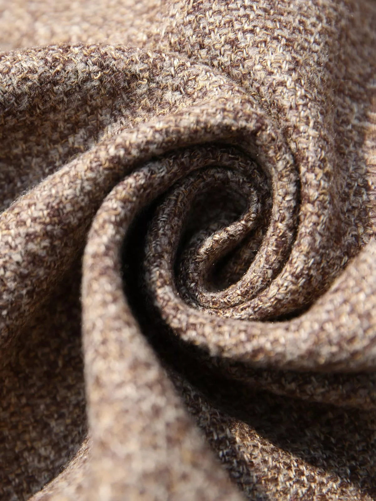 Close-up of brown textured fabric swirl, soft knit material for Shopimist apparel