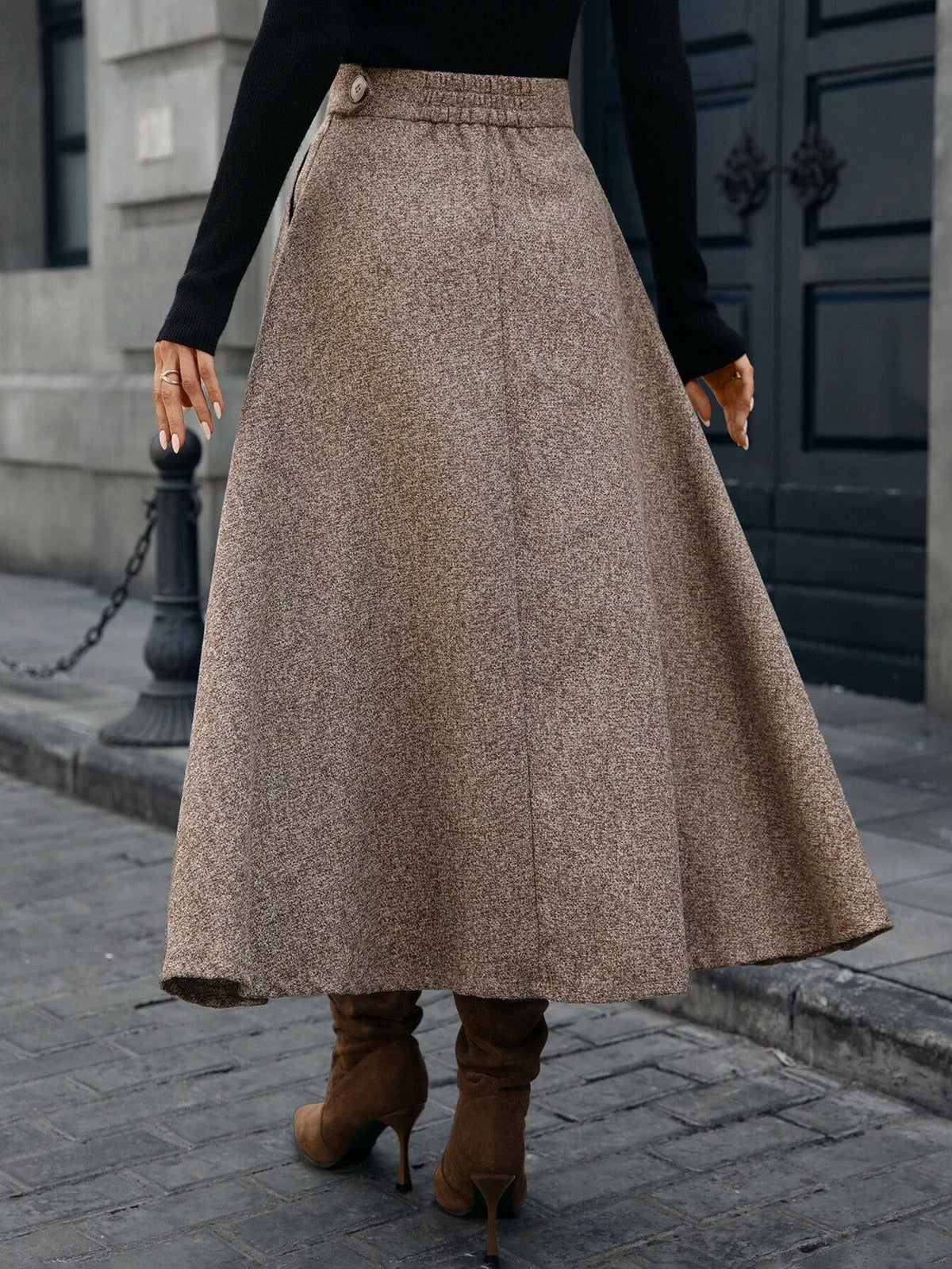 Woman wearing a brown wool maxi skirt and heeled boots, street style fashion by Shopimist